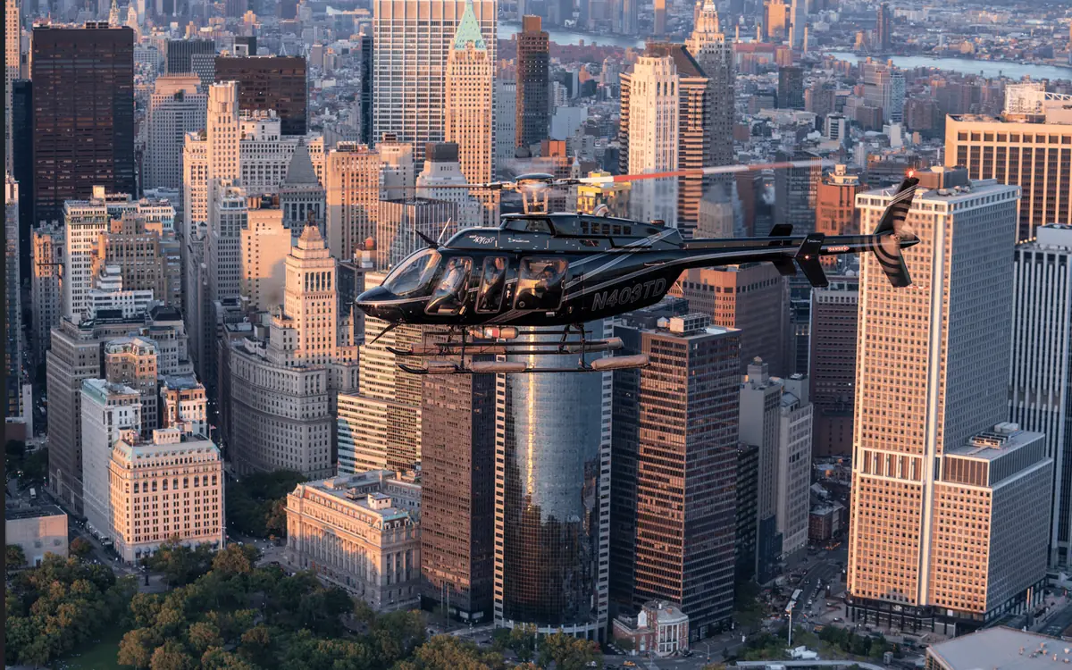 A helicopter on a pad on the New Jersey side of the Hudson with Manhattan beyond