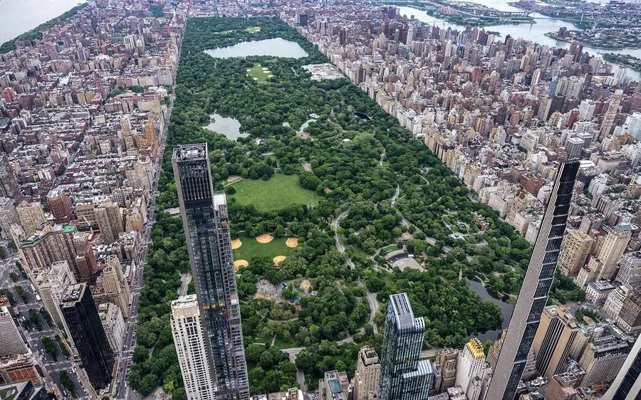 Two passengers side by side at a helicopter window over New York